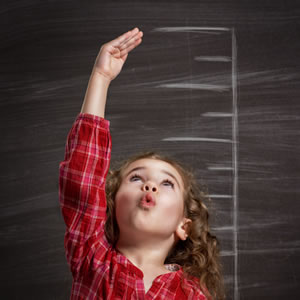 A little girl measuring her height growth